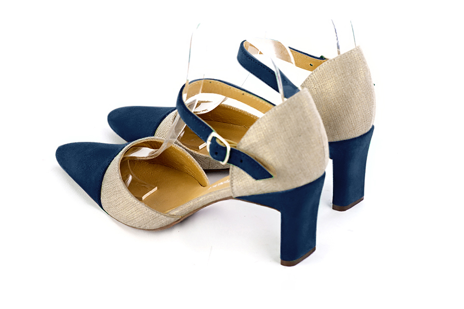 Women's navy blue and gold open side dress shoes, with an instep strap. Tapered toe. Medium comma heels - Rear view